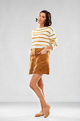 Image showing young woman in striped pullover, skirt and shoes