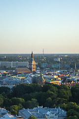 Image showing Riga Cathedral among old houses of town and green trees.