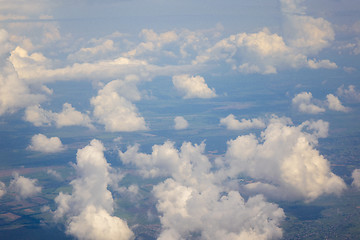 Image showing White clouds in the sky above country landscape.