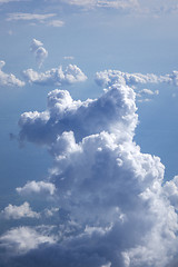 Image showing Vertical background of big clouds in a blue clear sky.