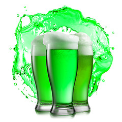 Image showing Glasses of green beer on a background of green splash.