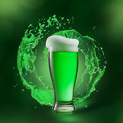 Image showing Glass of beer drink with green splash behind it.