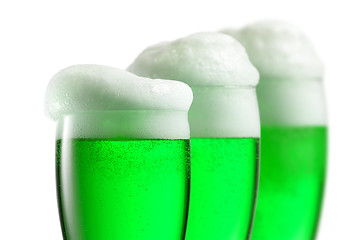 Image showing Fresh green beer with thick foam in the glasses.