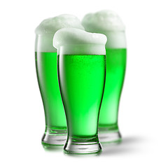 Image showing Alcoholic green beer in the glasses on a white.