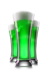 Image showing Green beer in glasses isolated on a white background.