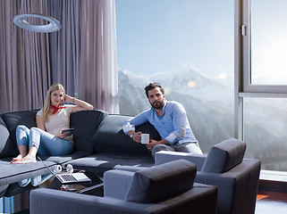 Image showing couple relaxing at  home with tablet computers