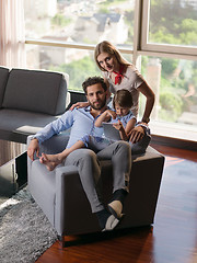 Image showing happy young couple spending time with kids