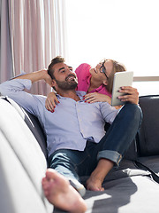 Image showing couple relaxing at  home with tablet computers