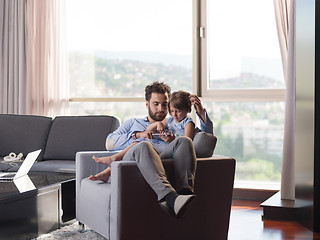 Image showing girl and her handsome father using a digital tablet