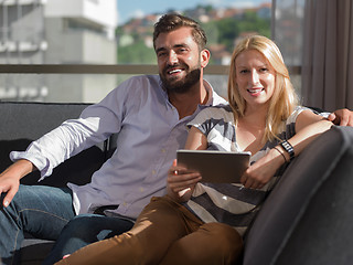 Image showing couple relaxing at  home with tablet computers