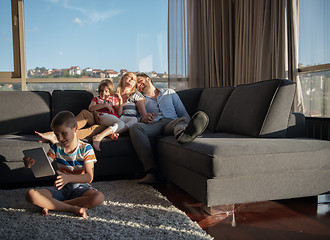 Image showing happy young couple spending time with kids at home