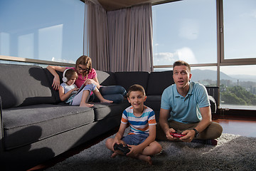 Image showing Happy family playing a video game