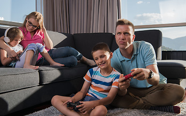 Image showing Happy family playing a video game