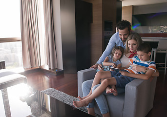 Image showing happy young couple spending time with kids