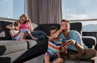 Image showing Happy family playing a video game