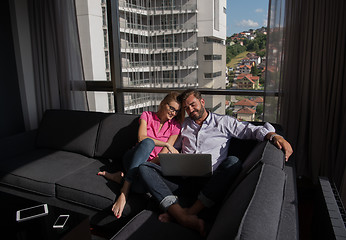 Image showing couple relaxing at  home using laptop computers