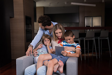 Image showing happy young couple spending time with kids