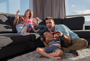 Image showing Happy family playing a video game