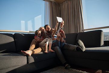 Image showing happy young couple spending time with kids at home