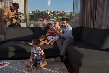 Image showing happy young couple spending time with kids at home