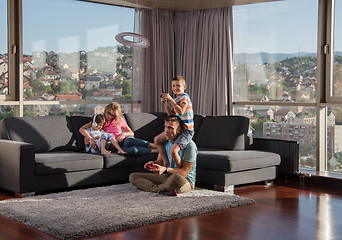 Image showing Happy family playing a video game