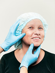 Image showing surgeon doing skin check on mid age woman before plastic surgery