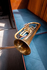 Image showing Blowing brass wind instrument on the bench