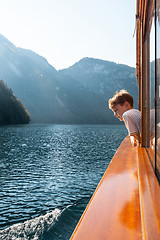 Image showing Konigssee lake, Bavaria - August 19, 2018: Unknown boy looking at green water of Konigssee, known as Germany deepest and cleanest lake