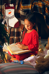 Image showing happy girl reading a book in the winter