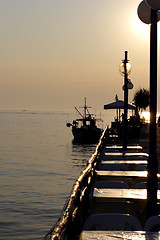 Image showing sunset over fishing village in greece