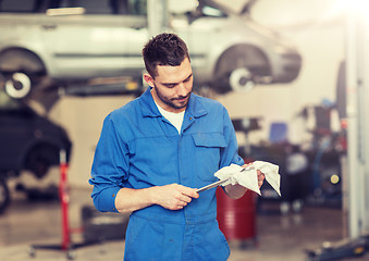 Image showing auto mechanic or smith with wrench at car workshop