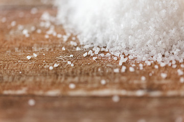 Image showing close up of white salt heap on wooden table