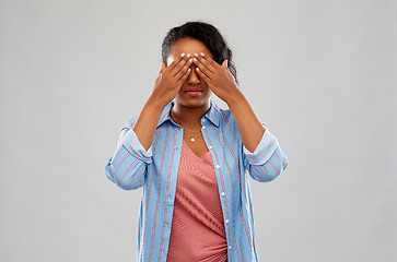 Image showing african american woman with eyes closed by hands