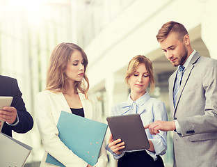 Image showing business team with tablet pc and folders at office