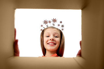 Image showing happy girl in tiara looking into open gift box