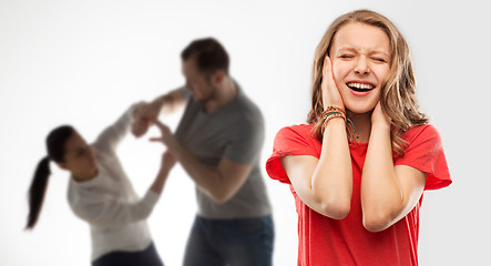 Image showing girl covering ears over her parents having fight