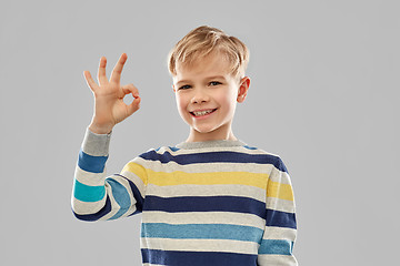 Image showing boy in striped pullover showing ok hand sign