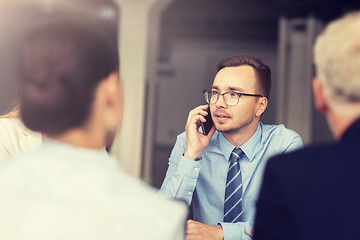 Image showing businessman calling on smartphone at office