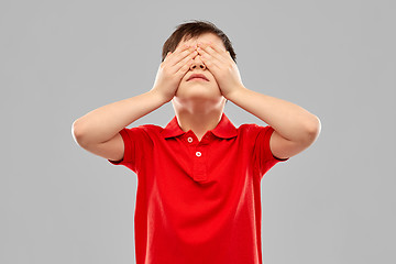 Image showing boy in red t-shirt closing his eyes by hands