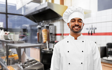 Image showing happy male indian chef in toque at kebab shop