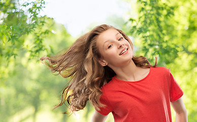 Image showing smiling teenage girl over natural background