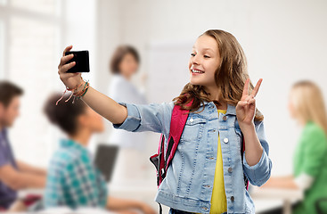 Image showing teenage student girl taking selfie by smartphone