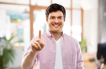 Image showing young man showing one finger over office room