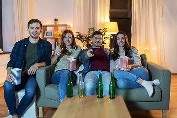 Image showing friends with beer and popcorn watching tv at home