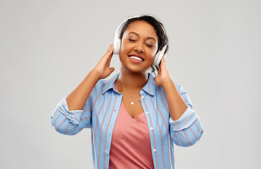 Image showing african woman in headphones listening to music