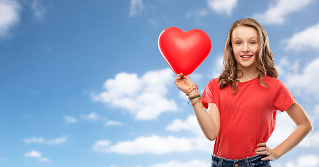 Image showing smiling teenage girl with red heart shaped balloon