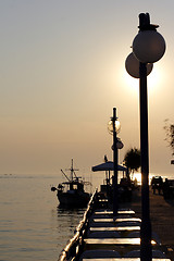 Image showing sunset over fishing village in greece