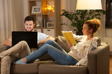 Image showing couple with laptop computer and book at home