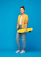 Image showing red haired teenage girl with short skateboard