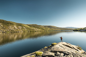 Image showing Man hiking near a beautiful lake